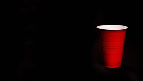a red plastic up against a black background.