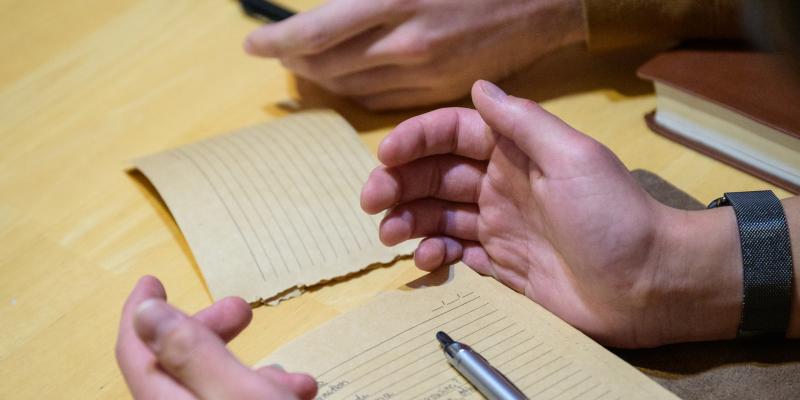 journal and open hands in prayer