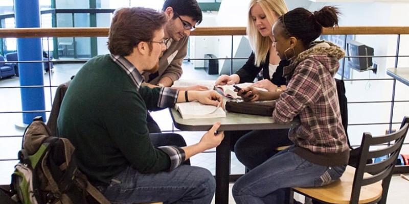 Group of diverse students gathered for Bible study in college student center