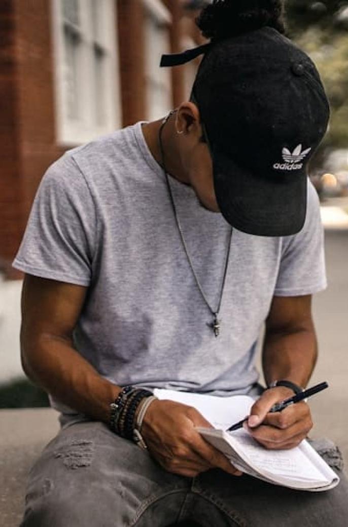 black student writing on a notepad
