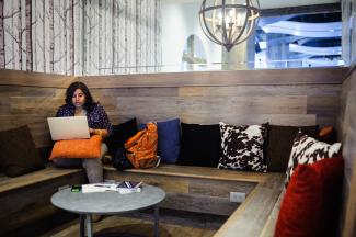 woman sitting and looking at her laptop