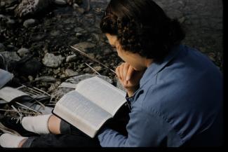 female student reading bible