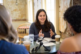 Young Latina woman interviewing students