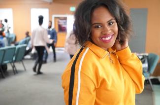 Woman in yellow smiling