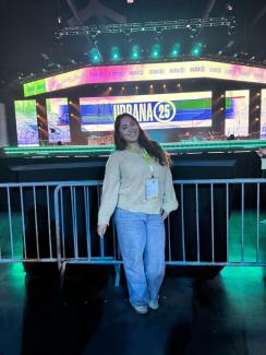 Angelica smiling in front of stage at Urbana 25