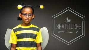 young girl in bee costume, dark gray background