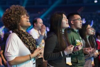 Diverse group of young men and women worshiping together