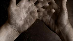 a close up of hands covered in ash and dirt