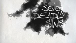 Ink blot on a white background with the words "Seven Deadly Sins" written on it.