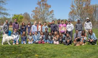 Group photo of students standing outside on lawn