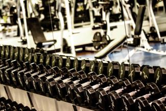 Rack of dumbbells in front of mirror in gym