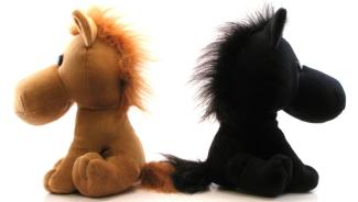 two stuffed horse dolls, one brown and the other black, facing in opposite directions