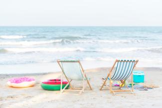 Couple of chairs and innertubes sitting on the beach