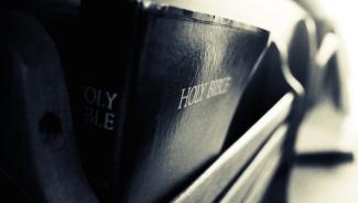 Leather bound Bible in pew rack close-up