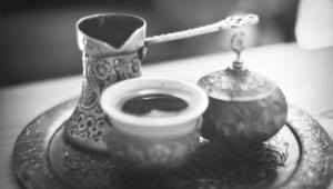 Black and white image of ornate coffee pot and cups