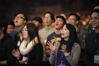 Group of people worshiping at church