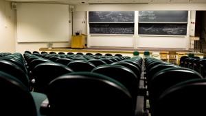 Empty classroom auditorium with stage and chalkboards