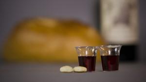 Two small communion cups and two pieces of bread