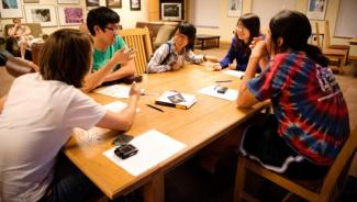 a group of students talking around a table