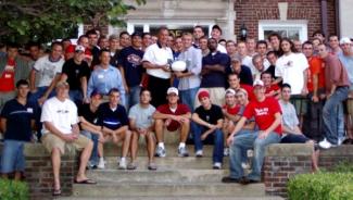 Group photo of male college students outside fraternity house