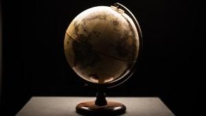 a globe sitting on a table in a dimly lit room