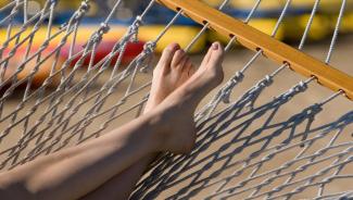 Closeup of person's feet propped up on hammock