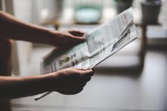 hands holding a newspaper