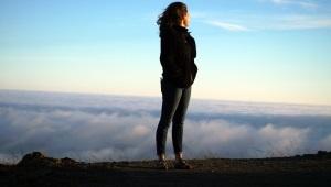 Woman standing on ridge overlooking mountains