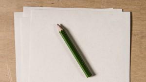 Blank pieces of paper with a pencil laying on top of them