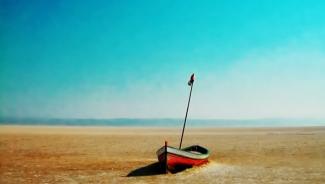 Red sailboat beached in dessert