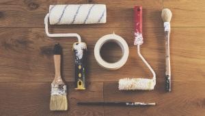 Set of tools on table including paint rollers and brushes