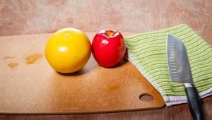 a wooden table with fruits, vegetables, and knife