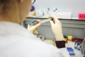 Medical researcher examining test tubes