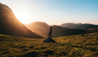 Person standing on rock in field