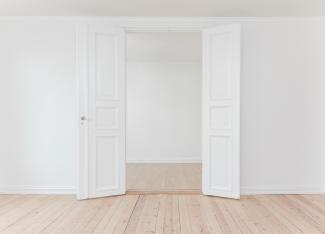 Empty rooms with plain white walls and open door