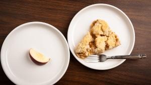 Plate with appetizing piece of pie next to another plate with a single apple slice