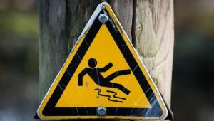 Slippery, wet floor yellow caution sign