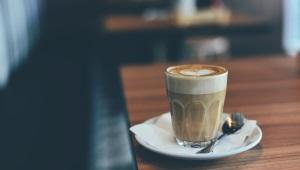 Single latte sitting on the edge of table