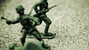 An image of toy soldiers in sand