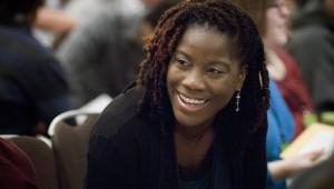 Closeup of woman smiling in conversation during conference