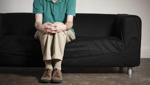 a man seated alone on a couch