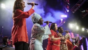 Diverse group of worship leaders singing at Urbana