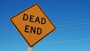 a yellow road sign reading "Dead End"