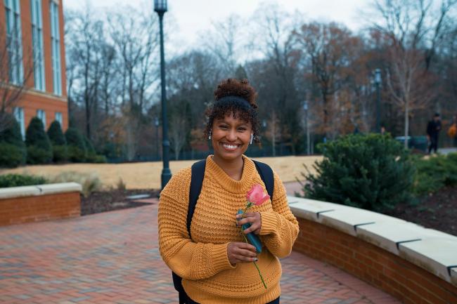 black student holding a flower