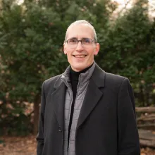 Jason smiling with a nature background