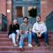 Elijah sitting on steps with two friends