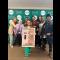 Group of students on campus with poster