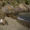 student reading and praying by water