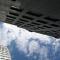 a blue sky with white clouds above two skyscrapers