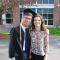 Taylor standing with friend Edwin in his graduation robe